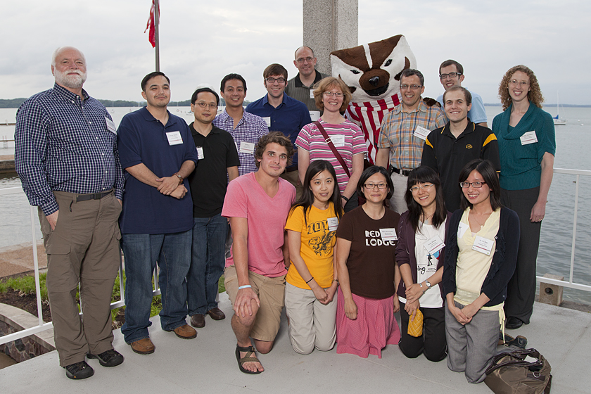 Group photo of people standing in front of windows