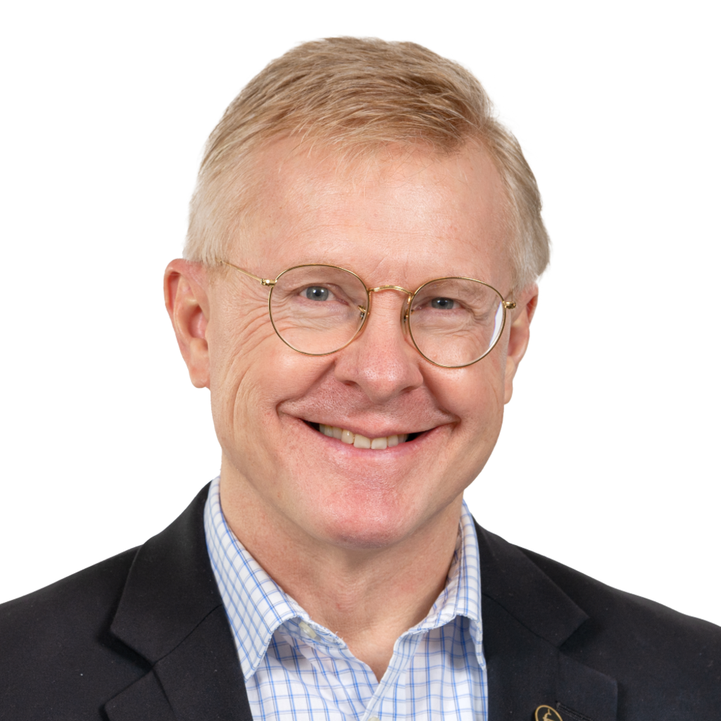 Man in a suit smiling at the Camera